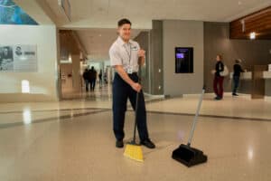 ccs employee sweeping the lobby of a government building
