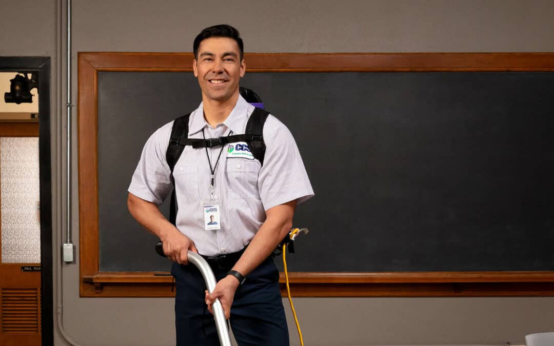 ccs janitor vacuuming a classroom