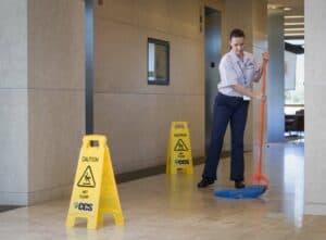 CCS Female mopping the floor of a lobby