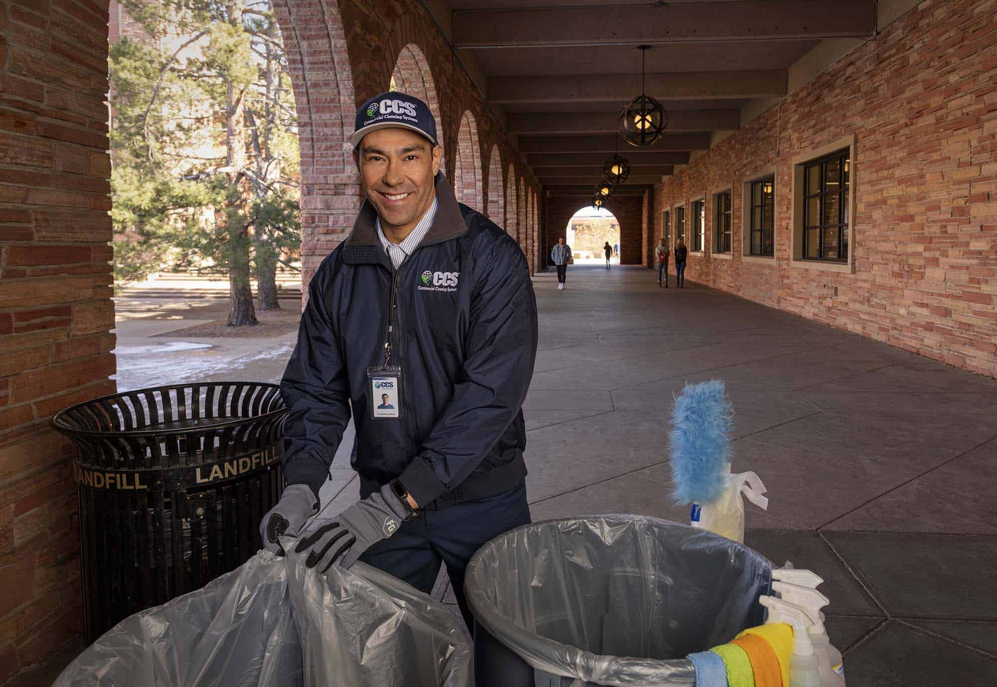 ccs employee taking the trash out of an educational facility