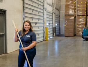 CCS employee moping the inside of a distribution center