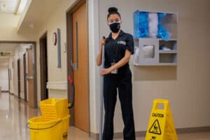 ccs employee moping the hallways of a medical facility