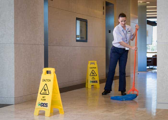 CCS male using an industrial mop to clean a commercial real estate facility
