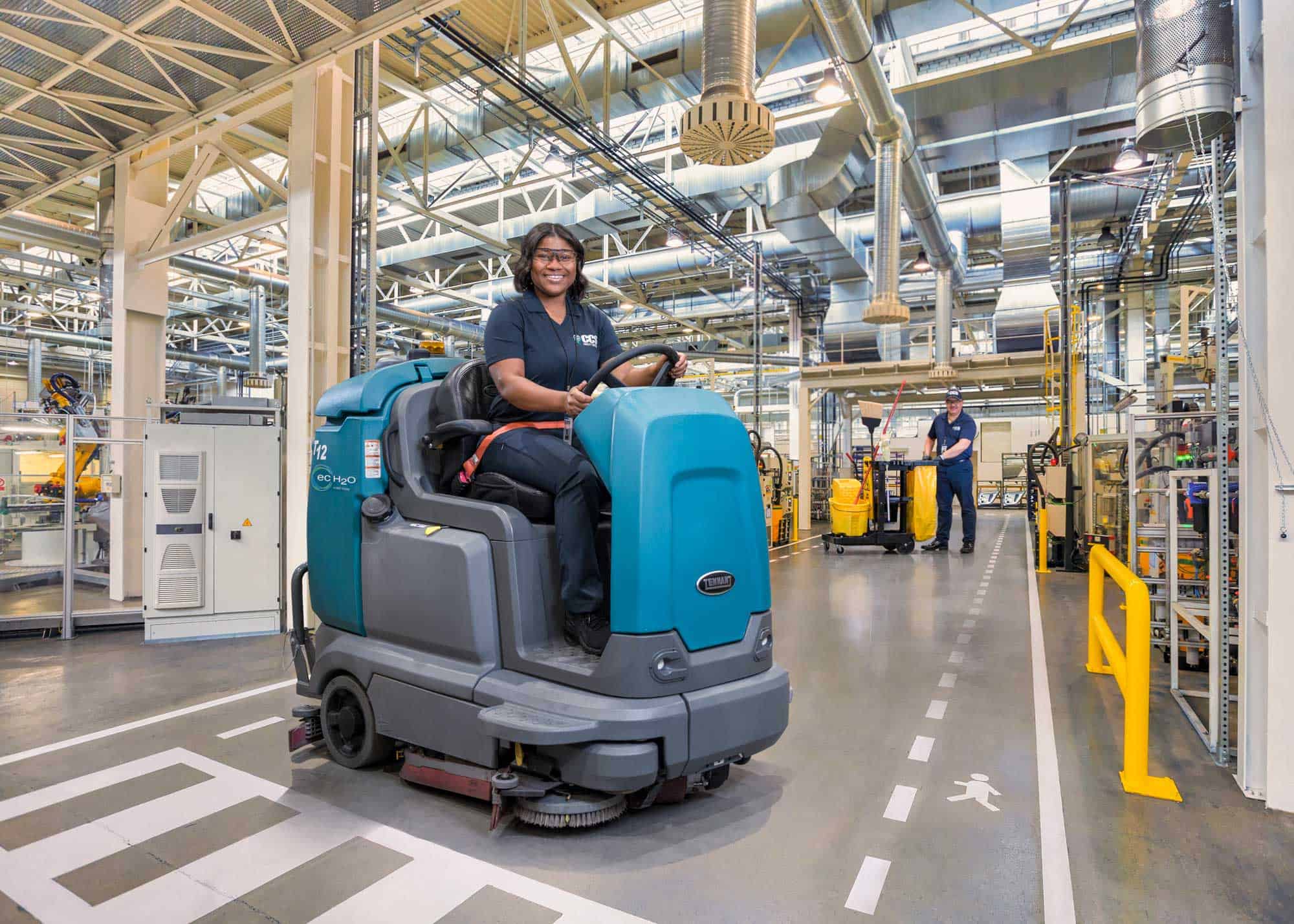 woman driving cleaning machine