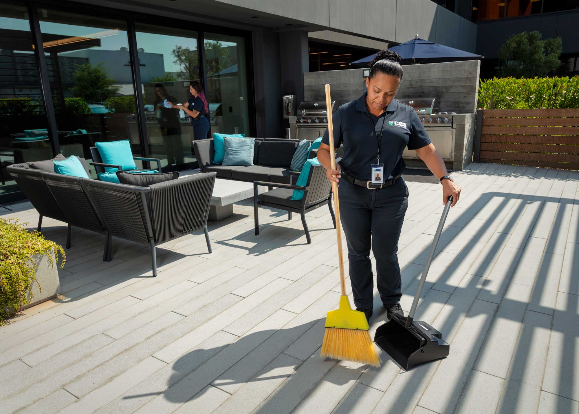 woman sweeping outside