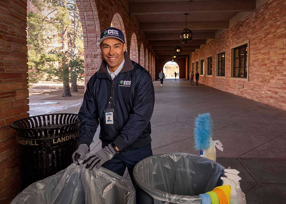 ccs employee taking the trash out of an educational facility