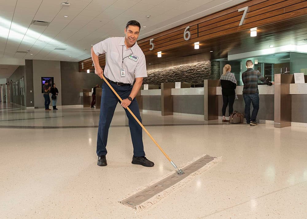 man sweeping lobby