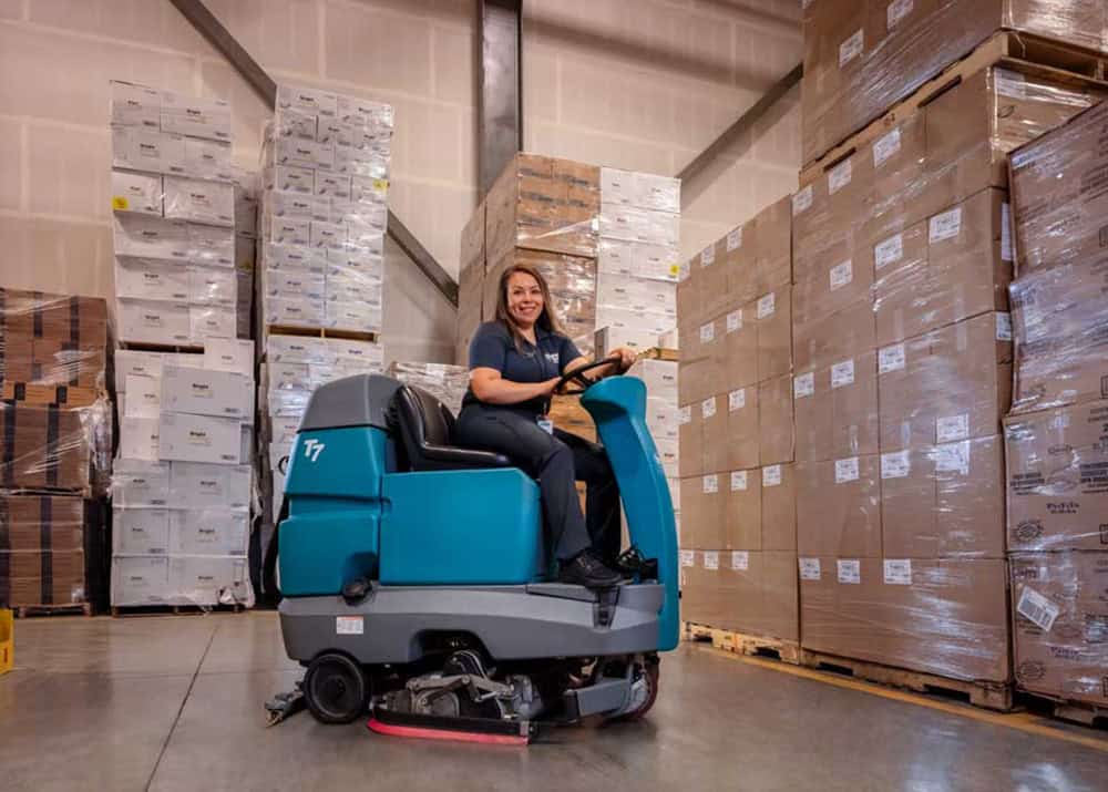 woman power cleaning warehouse